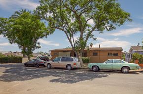 Los Angeles apartment for rent - Three cars parked in a driveway in front of a house.