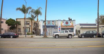 Los Angeles apartment for rent - A street view with cars and palm trees.