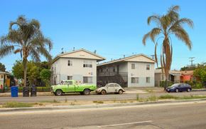 Los Angeles apartment for rent - A green truck is parked in front of a white house.