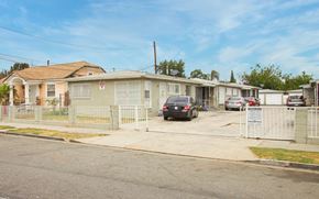 Compton apartment for rent - A residential street with houses and cars parked on the side.