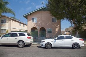 Long Beach apartment for rent - Two cars parked in front of a house.