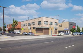 Los Angeles apartment for rent - A street view of a building with cars parked in front.