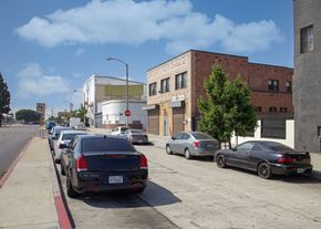 Los Angeles apartment for rent - Cars parked on the side of a street with buildings in the background.