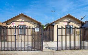 Los Angeles apartment for rent - Two houses with gates in front of them.