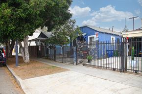 Los Angeles apartment for rent - A blue building with a red sign on it.