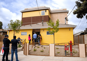 Los Angeles apartment for rent - a group of people standing outside of a yellow house