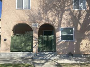 Long Beach apartment for rent - A building with a green gate and a window.