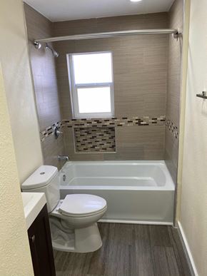 Los Angeles apartment for rent - A white toilet sits next to a bathtub in a bathroom.