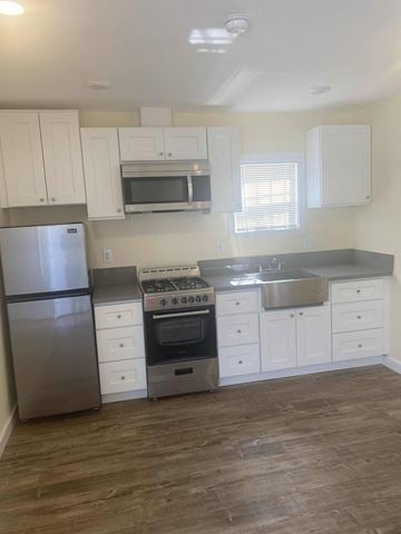 Los Angeles apartment for rent - A kitchen with a stainless steel refrigerator, oven, and microwave.