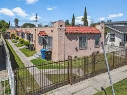 Los Angeles apartment for rent - A house with a red roof is surrounded by a black fence.