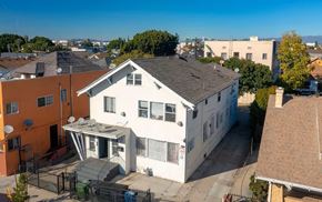 Los Angeles apartment for rent - A white house with a black gate in front of it.