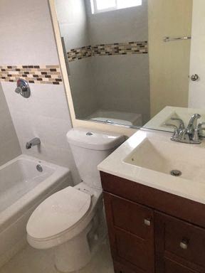 Los Angeles apartment for rent - A white toilet sits next to a sink in a bathroom.