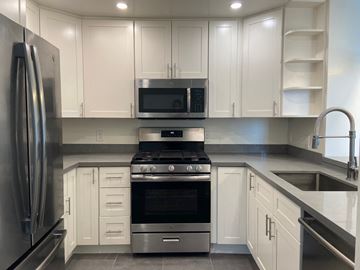 San Francisco apartment for rent - a kitchen with white cabinets and stainless steel appliances