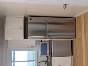Oakland apartment for rent - a kitchen with white cabinets and stainless steel appliances