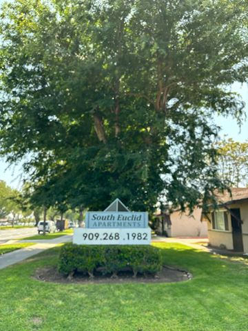 Ontario apartment for rent - A tree is in front of a sign for South Euclid Apartments.