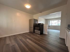 Ontario apartment for rent - A room with a wood floor and a wall-mounted TV.