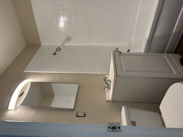 Ontario apartment for rent - A bathroom with a toilet, sink, and shower.