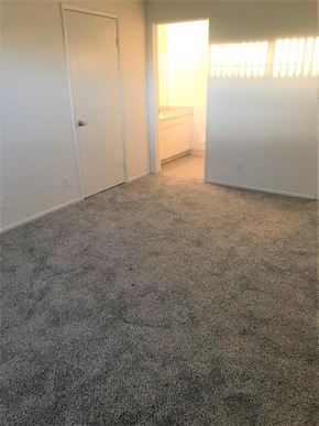 Glendale apartment for rent - A room with a carpeted floor and a window letting in sunlight.