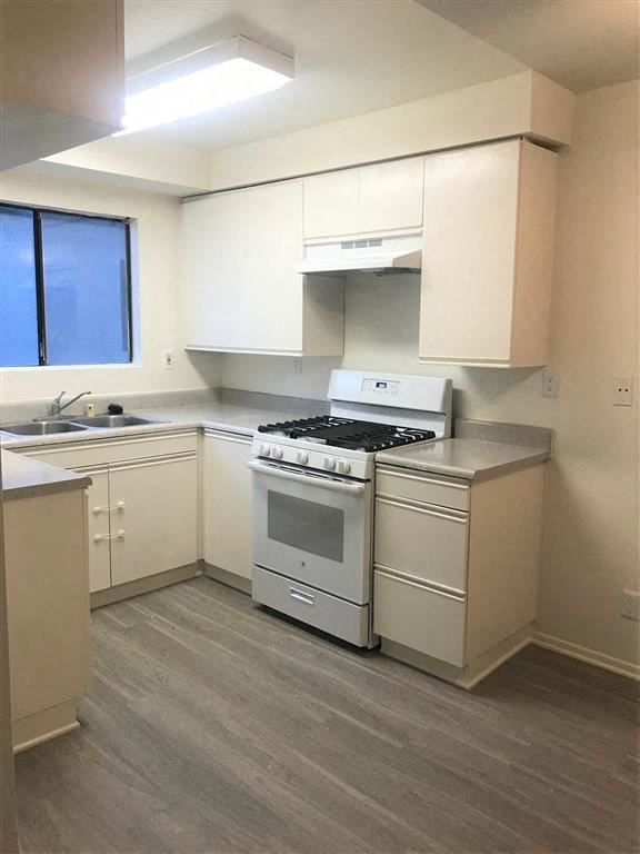 Glendale apartment for rent - A kitchen with a white stove and cabinets.