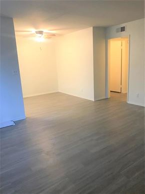 Glendale apartment for rent - A room with a wooden floor and a door on the right side.