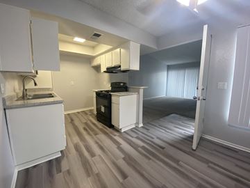 Ontario apartment for rent - A kitchen area with a sink, stove, and cabinets.