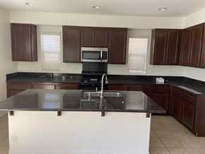 Fontana house for rent - a kitchen with a counter top and a sink