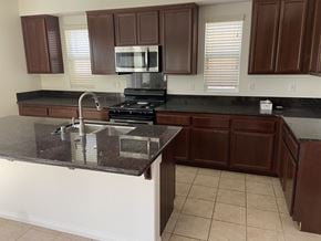 Fontana house for rent - a kitchen with a counter top and a sink
