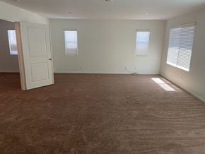 Fontana house for rent - an empty living room with carpet and a white door
