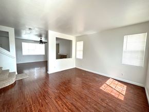 Victorville house for rent - A room with wooden floors and a window letting in sunlight.
