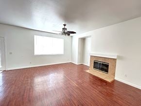 Victorville house for rent - A room with a fireplace and wood flooring.