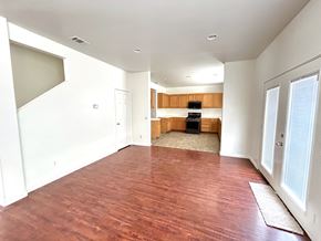 Victorville house for rent - A room with wooden flooring and white walls.