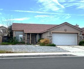 Hesperia house for rent - A house with a garage and a driveway in front.