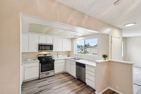 West Covina apartment for rent - the preserve at ballantyne commons spacious kitchen with white cabinets and stainless steel appliances