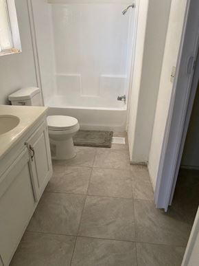 Adelanto house for rent - A white toilet is in a bathroom with a tiled floor.