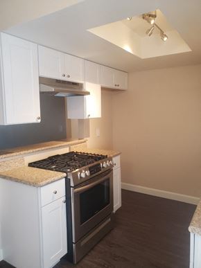Ontario apartment for rent - a kitchen with white cabinets and a stove
