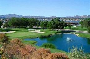Victorville apartment for rent - a golf course with a body of water and trees
