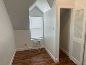 Pomona house for rent - a room with a window and a wooden floor and an air conditioner