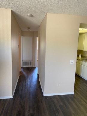 Ontario townhouse for rent - A long hallway with wood floors and white walls.