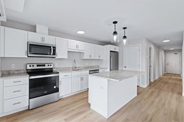Scarborough apartment for rent - A modern kitchen with white cabinets and a marble island.