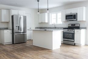 Brunswick apartment for rent - A kitchen with a refrigerator, oven, and microwave.