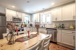 South Portland apartment for rent - A kitchen with a table and chairs in the foreground.