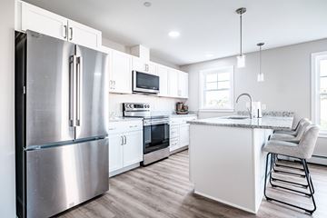 Windham apartment for rent - A modern kitchen with a stainless steel refrigerator and white cabinets.