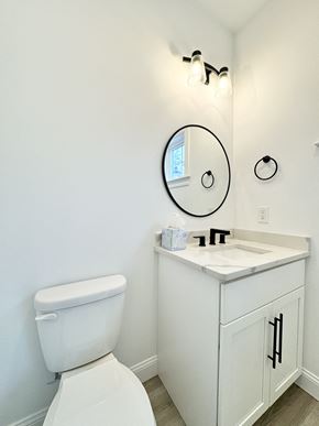 Scarborough townhouse for rent - a bathroom with a toilet and a sink and a mirror