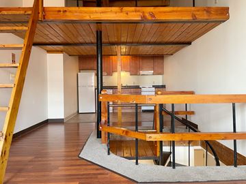 Portland apartment for rent - a view of a living room and kitchen from the top of a staircase