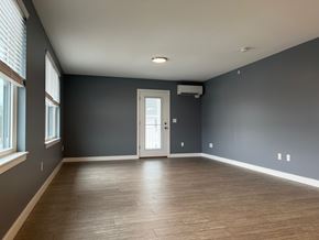 Scarborough apartment for rent - A room with a wooden floor and a white door.