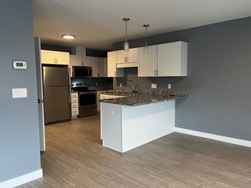 Scarborough apartment for rent - A kitchen with a refrigerator, oven, and microwave.