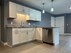 Scarborough apartment for rent - A kitchen with a granite countertop and white cabinets.