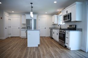 Brunswick apartment for rent - a kitchen with white cabinets and stainless steel appliances