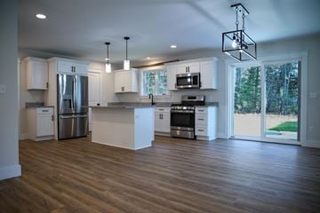 Brunswick apartment for rent - a kitchen with white cabinets and stainless steel appliances