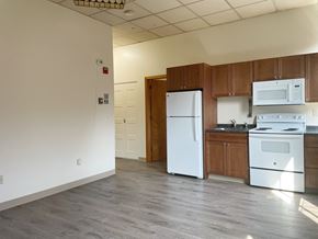 Portland apartment for rent - an empty kitchen with white appliances and wooden cabinets